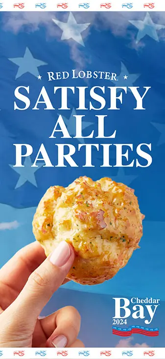 A hand holding a cheddar bay biscuit over a background of the United States flag. Text reads Satisfy All Parties